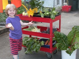 eloise showing off some of today's vegetables